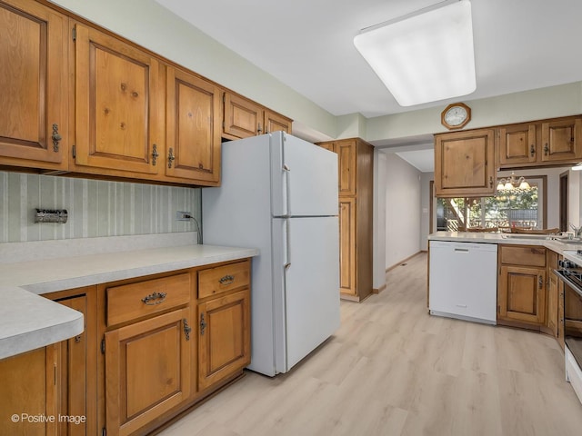 kitchen with white appliances and light wood-type flooring