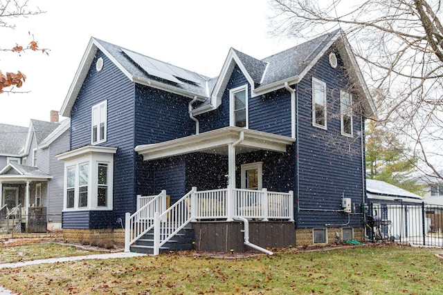 view of front of home featuring a front yard and a porch