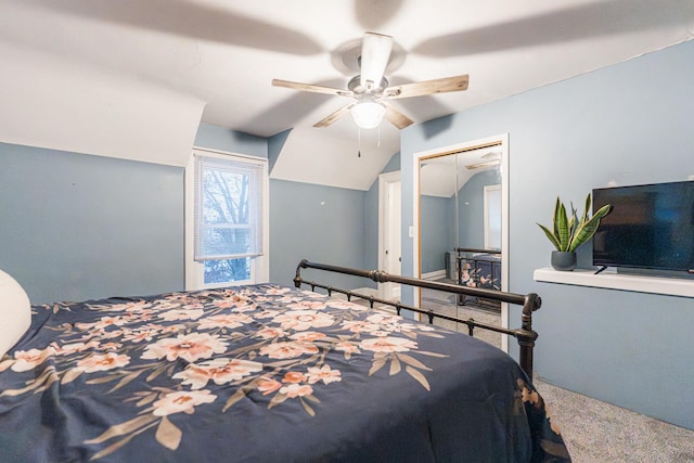 bedroom with ceiling fan, lofted ceiling, and carpet