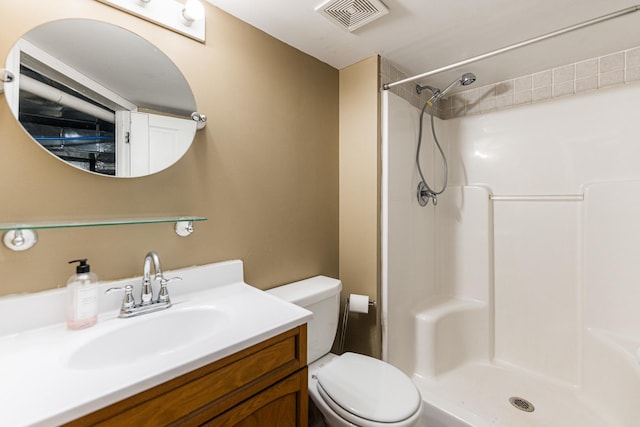 bathroom featuring vanity, toilet, and walk in shower