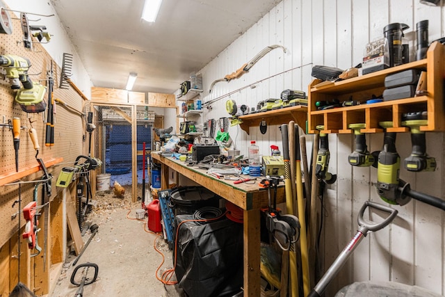 misc room featuring concrete flooring and a workshop area