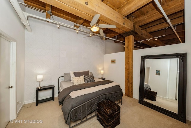 carpeted bedroom featuring track lighting