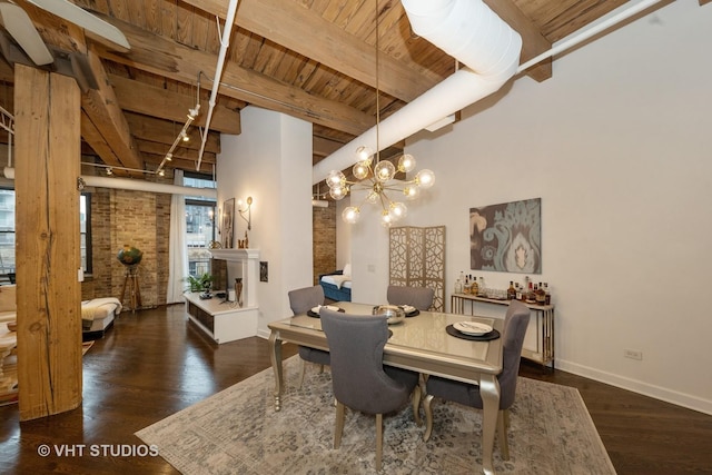 dining space with dark wood-type flooring, wood ceiling, beamed ceiling, brick wall, and a high ceiling