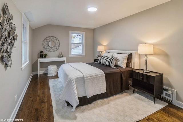 bedroom with lofted ceiling and hardwood / wood-style floors