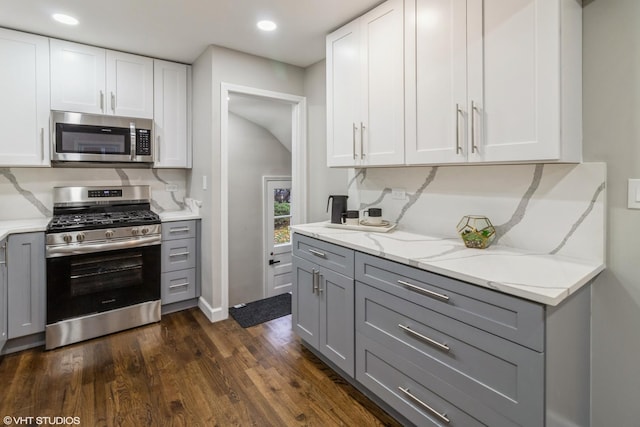 kitchen with gray cabinetry, white cabinetry, and appliances with stainless steel finishes