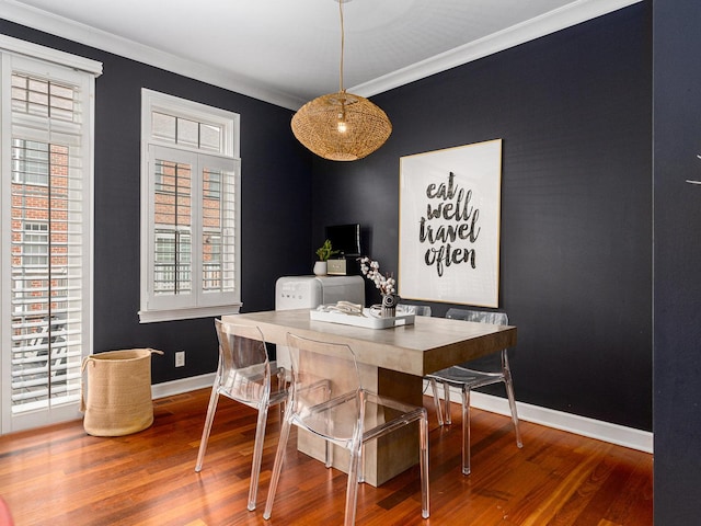 dining room featuring crown molding and hardwood / wood-style floors