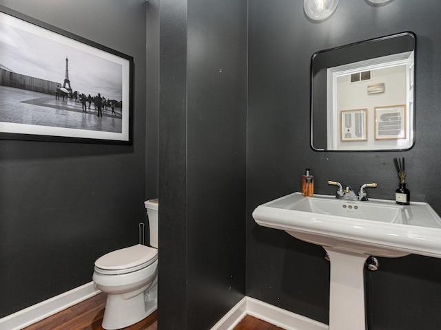 bathroom featuring hardwood / wood-style floors and toilet