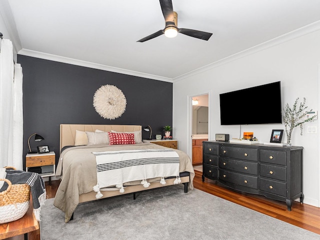 bedroom featuring crown molding, ceiling fan, wood-type flooring, and ensuite bathroom