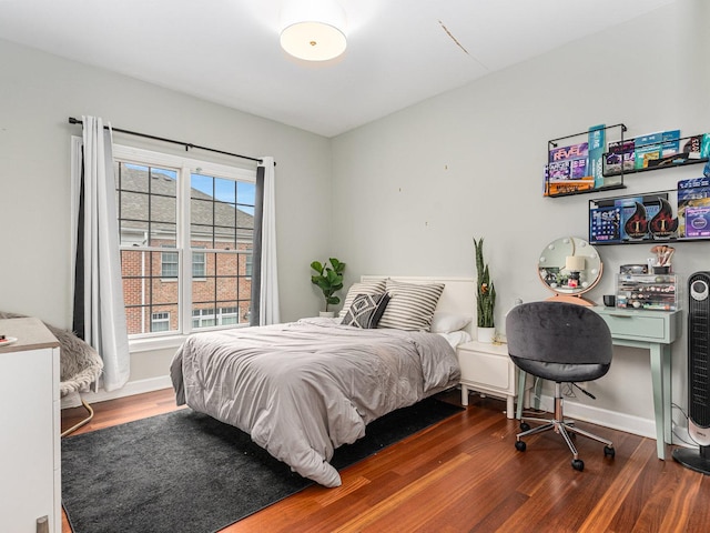 bedroom with dark hardwood / wood-style flooring