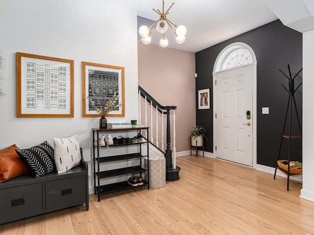 foyer with a chandelier and light wood-type flooring