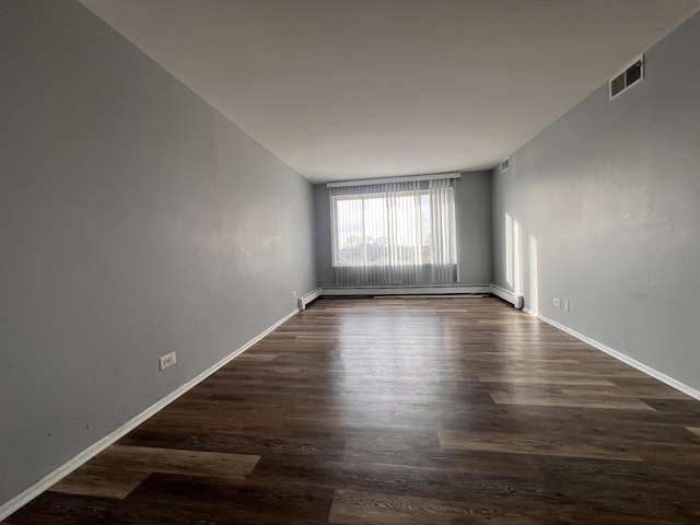 unfurnished room with a baseboard radiator and dark hardwood / wood-style flooring