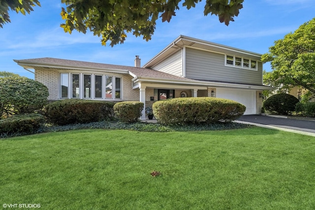 view of front facade with a garage and a front lawn