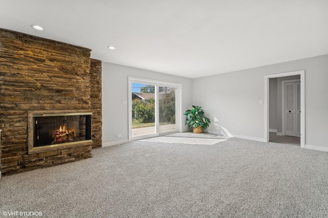 unfurnished living room featuring carpet floors and a brick fireplace