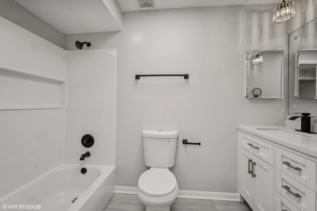 full bathroom featuring vanity, tiled shower / bath combo, and toilet