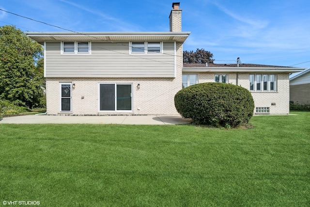 rear view of house featuring a yard and a patio area