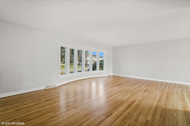 unfurnished room with light wood-type flooring