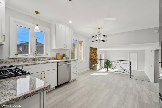 kitchen featuring light stone counters, an inviting chandelier, decorative light fixtures, dishwasher, and white cabinets