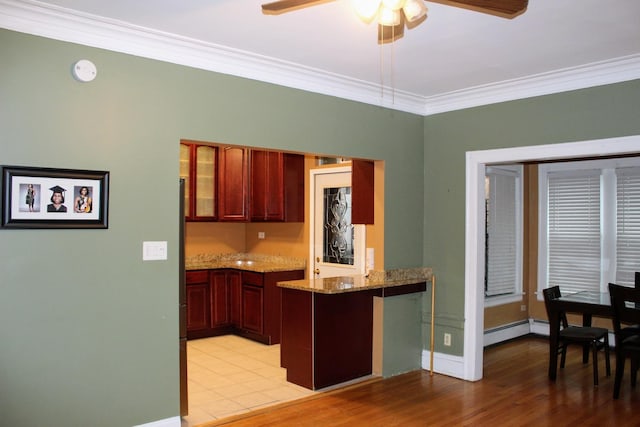 kitchen with a baseboard radiator, ornamental molding, light stone counters, kitchen peninsula, and light hardwood / wood-style flooring