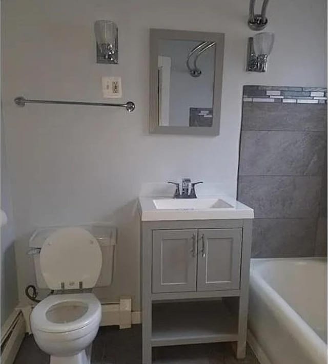 bathroom featuring vanity, toilet, and a baseboard heating unit