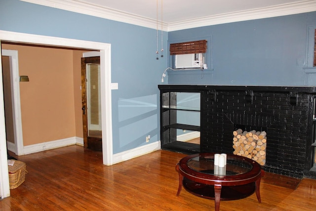 room details featuring crown molding, wood-type flooring, cooling unit, and a fireplace