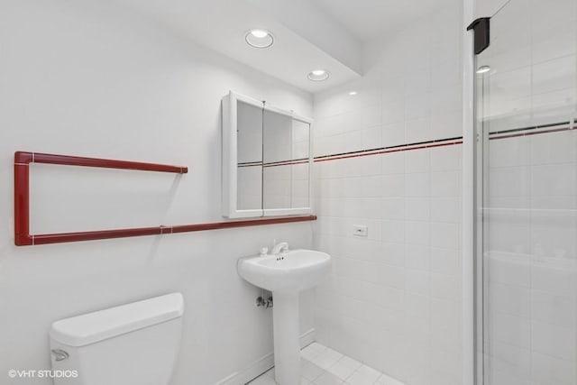 bathroom with toilet and an enclosed shower