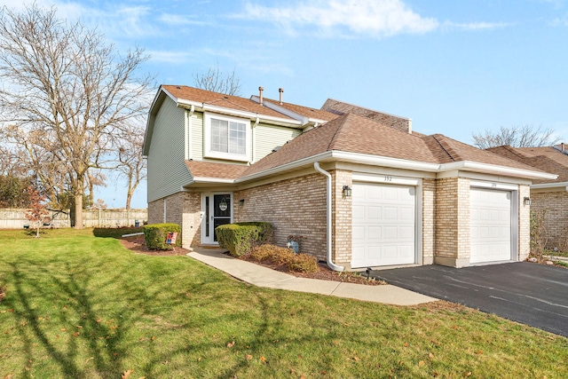 view of front facade with a garage and a front lawn