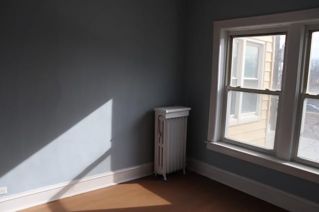 unfurnished room featuring radiator