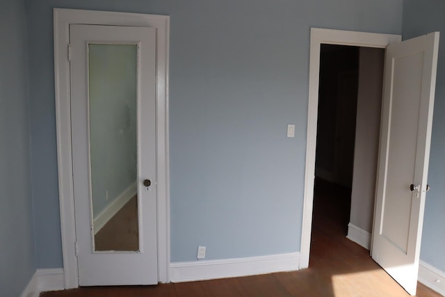 unfurnished bedroom with wood-type flooring