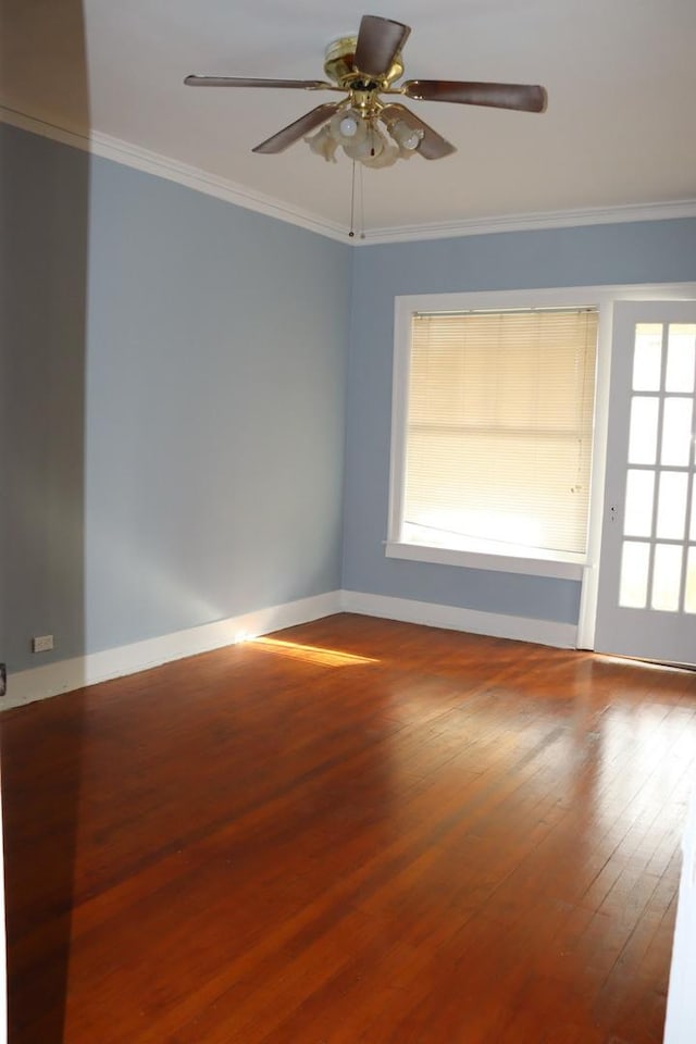 spare room with crown molding, plenty of natural light, wood-type flooring, and ceiling fan