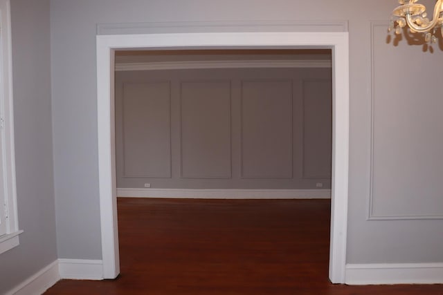 interior space featuring dark wood-type flooring and a chandelier