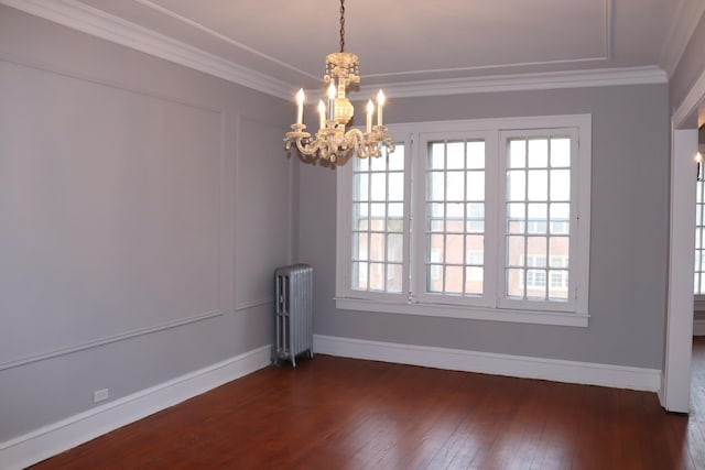 unfurnished dining area featuring crown molding, radiator, dark wood-type flooring, and an inviting chandelier