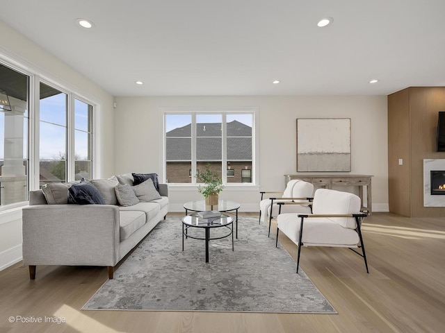 living area featuring recessed lighting, wood finished floors, and a healthy amount of sunlight