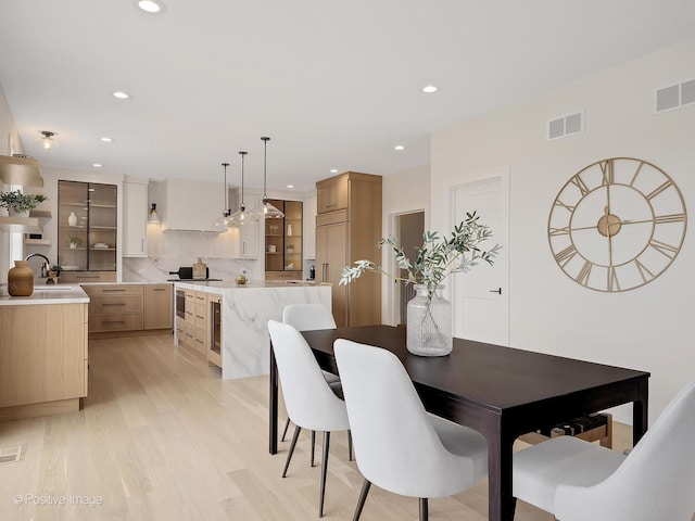dining area featuring recessed lighting, light wood finished floors, and visible vents