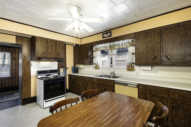 kitchen featuring white dishwasher, sink, dark brown cabinets, and range with gas cooktop