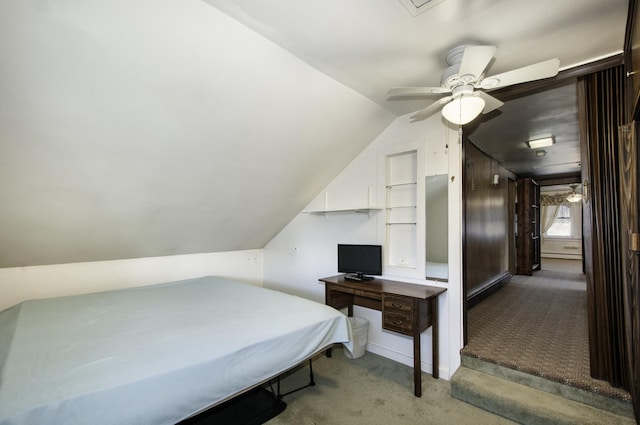 bedroom with ceiling fan, light colored carpet, and vaulted ceiling