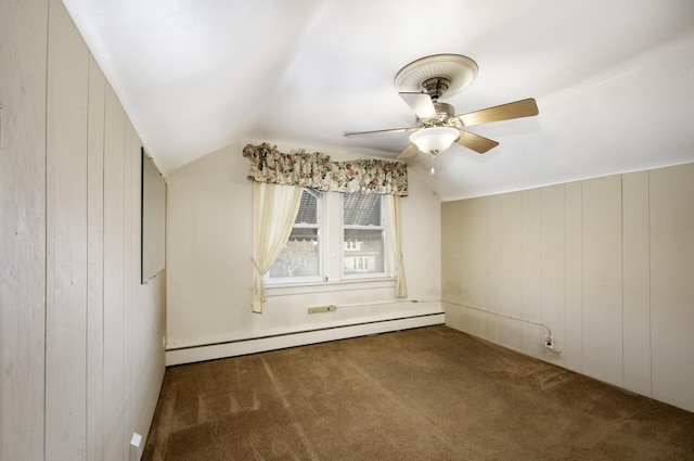 bonus room featuring ceiling fan, a baseboard heating unit, dark colored carpet, vaulted ceiling, and wood walls