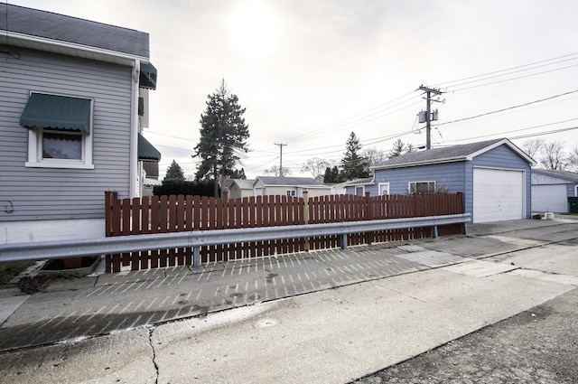 exterior space with a garage and an outbuilding