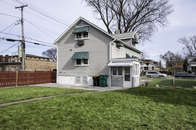 rear view of house with a yard and a patio area