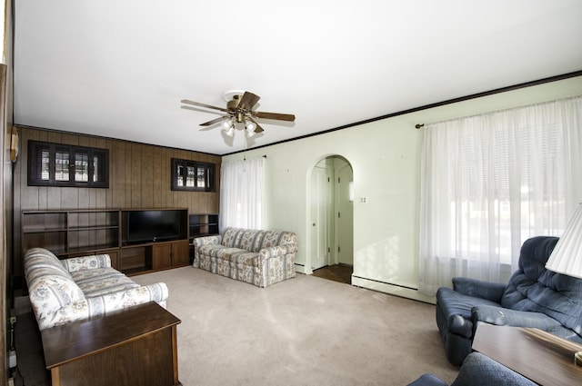 living room featuring carpet flooring, ornamental molding, ceiling fan, and baseboard heating