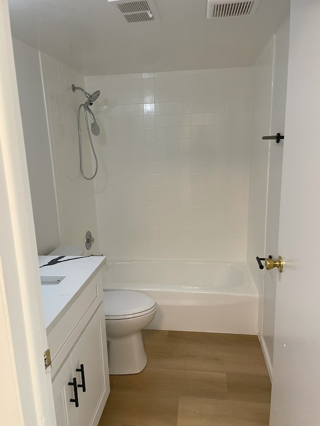 bathroom featuring wood-type flooring, toilet, and vanity