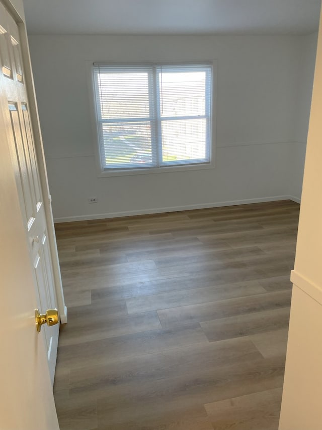 unfurnished room with dark hardwood / wood-style floors