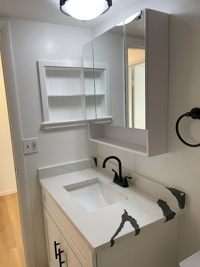 bathroom featuring hardwood / wood-style flooring and vanity