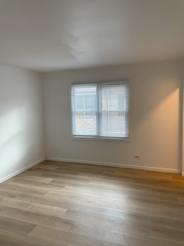 spare room with light hardwood / wood-style floors