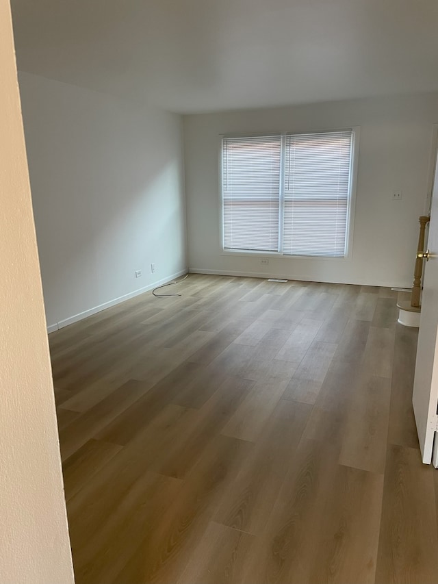 spare room with hardwood / wood-style flooring