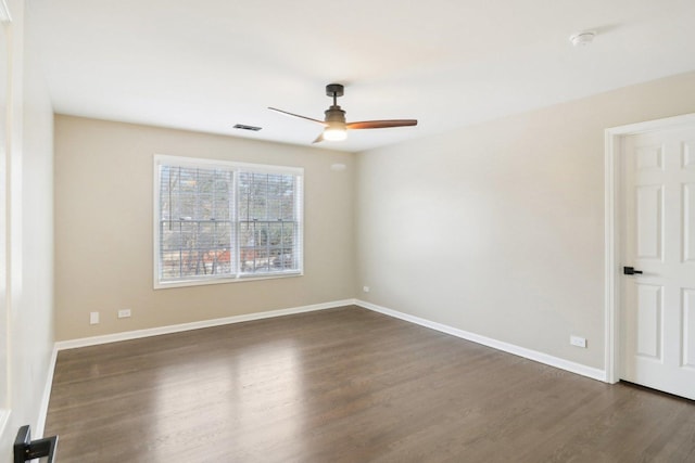 spare room featuring dark hardwood / wood-style floors and ceiling fan