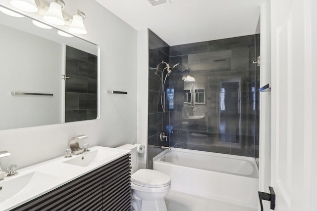 full bathroom featuring vanity, tiled shower / bath combo, and toilet