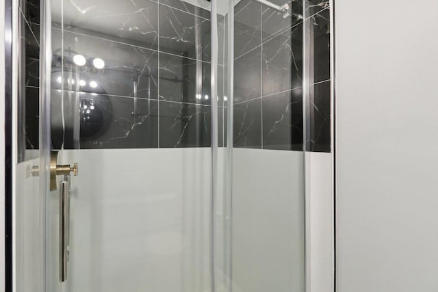 room details featuring a shower with door