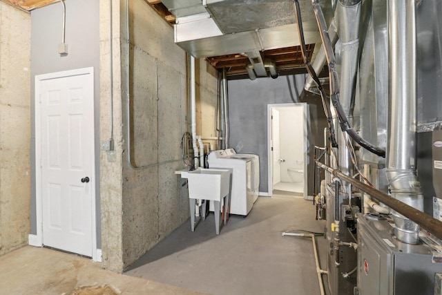 basement with separate washer and dryer and heating unit