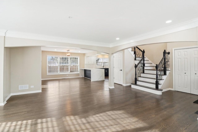 unfurnished living room featuring ornamental molding and dark hardwood / wood-style floors