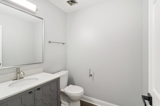 bathroom featuring vanity, toilet, and wood-type flooring